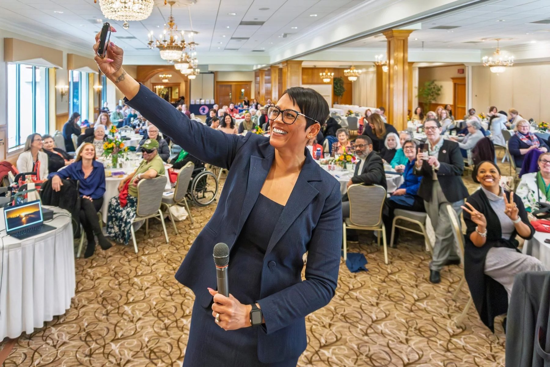 Lorrena Black with a microphone among the audience